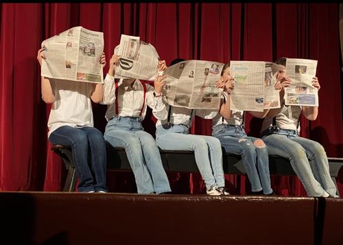 Dance students with paper